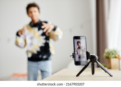 Background image of Gen Z teenager filming video for social media at home, focus on smartphone screen, copy space - Powered by Shutterstock