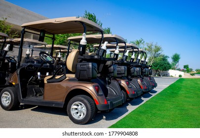 Background image of Golf carts parked on a golf closure in a line.Golf course - Powered by Shutterstock