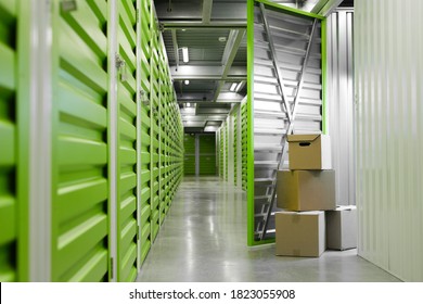Background image of green self storage facility with opened unit door and cardboard boxes, copy space - Shutterstock ID 1823055908