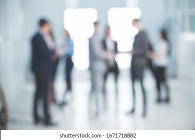 background image of a group of corporate employees in the office lobby - Powered by Shutterstock