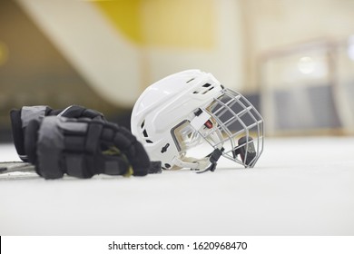 Background image of hockey equipment lying on ice in outdoor skating arena, copy space