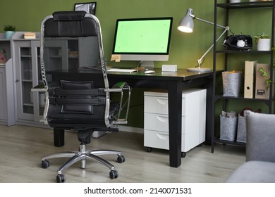 Background Image Of Home Office Workplace With Chroma Key Computer Screen On Desk Against Green Wall, Copy Space