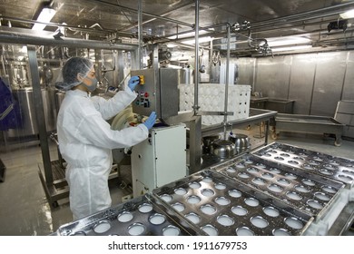 Background Image Of Industrial Conveyor Belt At Clean Food Production Factory With Unrecognizable Female Worker Operating Machine Units, Copy Space