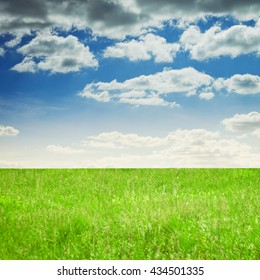 Background image of lush grass field under blue sky