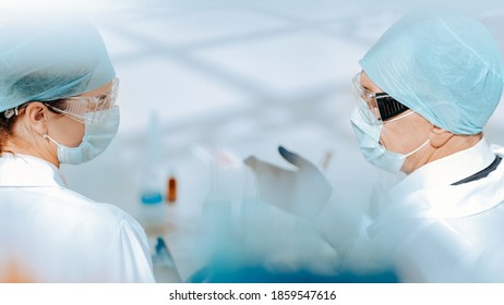 Background Image Of Medical Colleagues Talking In The Lab.