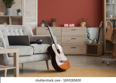 Background Image Of Modern Room Interior With Music Instruments And On Air Sign, Focus On Guitar In Foreground, Copy Space