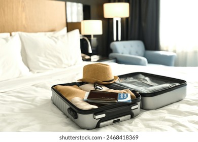 Background image of packed suitcase with passport and tickets on bed ready for travel concept