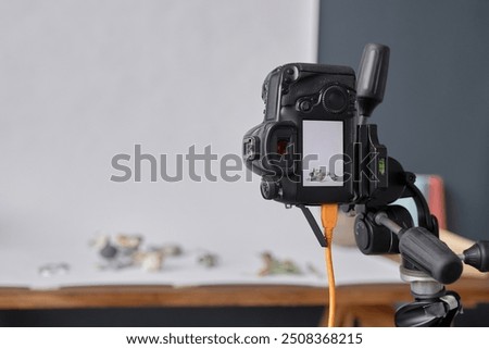 Background image of professional DSLR camera mounted on tripod in photographers studio during commercial product photoshoot copy space