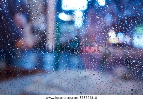 Background\
image of the raindrop on the windshield with nice bokeh blur in the\
bad traffic.                               \
