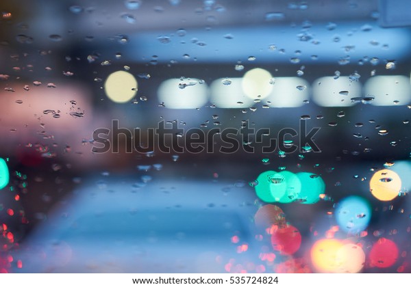 \
Background image of the raindrop on the windshield with nice bokeh\
blur in the bad traffic.                            \
