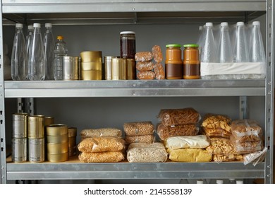 Background Image Of Shelves Stacked With Food Donations At Help Center For Refugees And People In Need, Copy Space