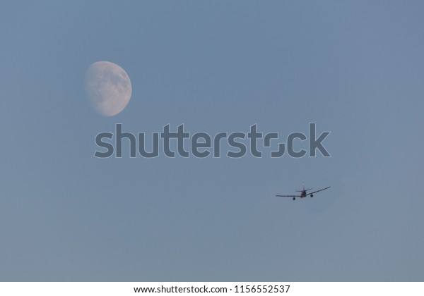 background image of the sky with the moon and the\
plane flying towards\
it