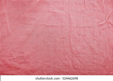 Background Image With A Slightly Wrinkled Red And White Traditional Italian Checkered Tablecloth