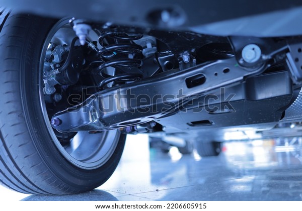Background image. Suspension components. Of the\
car. Shock, spare tire, wheel,\
brake.