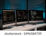 Background image of three computer monitors with code lines on table in IT development office, copy space