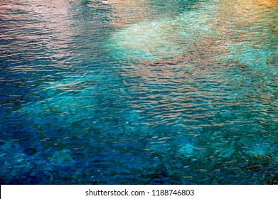 Background image from turquoise blue ocean ripples. Horizontal photo.