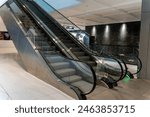 Background image with two escalators in shopping mall, empty electric escalator preparing before opening time in morning