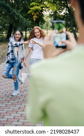 Background Image Of Two Gen Z Teenagers Dancing Making Popular Videos And Showing The Heart Sign For Their Followers. Positive Person. Summer Holidays. City