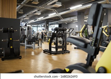 Background image of various exercise machines in workout hall of modern gym interior, copy space
