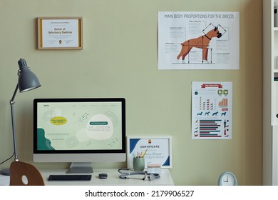 Background Image Of Vet Clinic Interior, Focus On Workplace Desk With Computer And Certificates Of Vet Expert On Wall, Copy Space