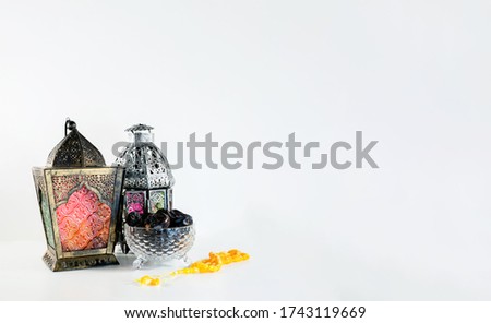 Background image with white background with arabic lantern, dates and beads.
