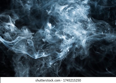 Background image of a wisp of smoke on a dark background. The texture of the flowing smoke. Frozen smoke on a dark background. Graphic resources dark backdrop. Curls of smoke frozen in motion. - Shutterstock ID 1745215250