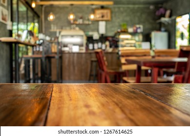 Background Image Wood Table Top On Blur Coffee Shop Background