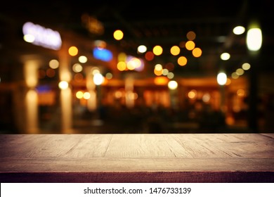 background Image of wooden table in front of abstract blurred restaurant lights - Shutterstock ID 1476733139