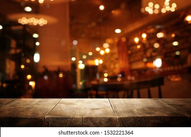 background Image of wooden table in front of abstract blurred restaurant lights - Shutterstock ID 1532221364