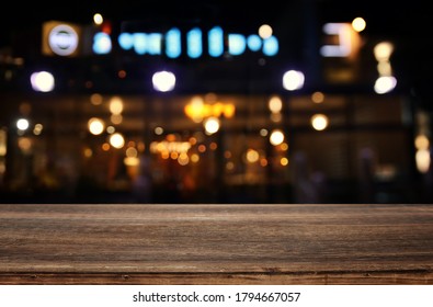 background Image of wooden table in front of abstract blurred restaurant lights - Shutterstock ID 1794667057