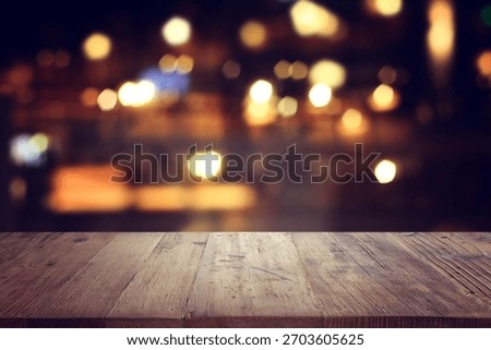 background Image of wooden table in front of abstract blurred restaurant lights