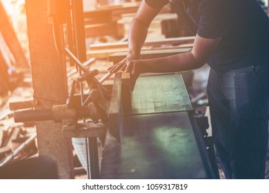 Background image of woodworking workshop: carpenters work table with different tools and wood cutting stand, vintage filter image - Shutterstock ID 1059317819