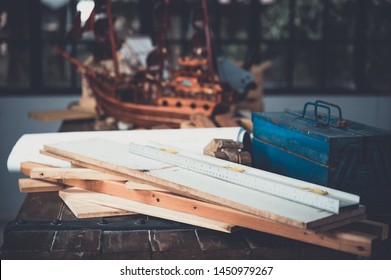 Background image of woodworking workshop, carpenters work table with different tools and wood cutting stand, vintage filter image - Shutterstock ID 1450979267