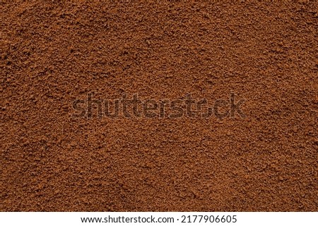 Background of instant coffee closeup, banner. Coffee powder texture, top view. Ground, instant coffee background, texture, top view. Texture of brown coffee powder, banner.