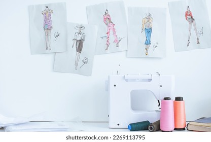 Background of interior tailor shop or room with nobody, there is sewing machine on table and paper of clothing design on wall. Lifestyle and small business concept - Powered by Shutterstock