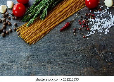 Background With Italian Food. Ingredients For Cooking Over Dark Wooden Board (with Easy Removable Sample Text).