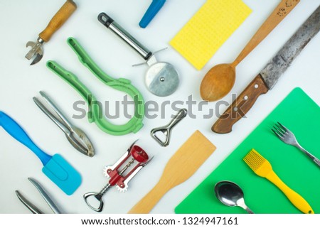 Background of kitchen utensils on white wooden kitchen table. tools. Top view