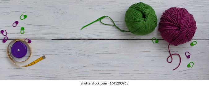 Background with knitting tools and accessories, colorful skein yarn, hobby concept, copyspace, top view, banner