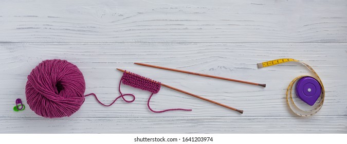 Background with knitting tools and accessories, colorful skein yarn, hobby concept, copyspace, top view