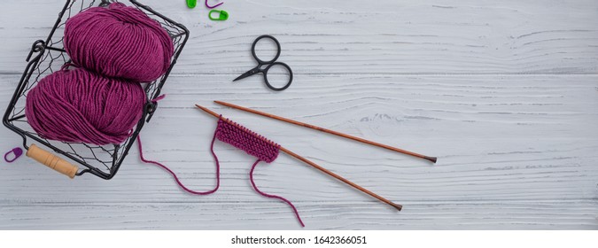 Background with knitting tools and accessories, colorful skein yarn, hobby concept, copyspace, top view