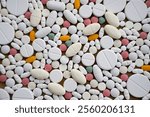 background of a large number of tablets of different sizes and colors. possible concept: pharmacology, advertising of drugs, production of drugs,pharmacy.