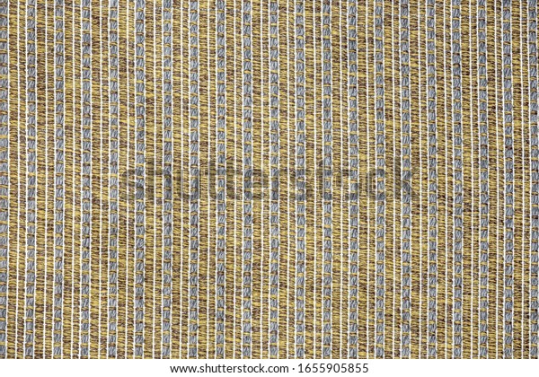 Background of lined brown coarse fabric, beige\
carpet texture with seam\
lines