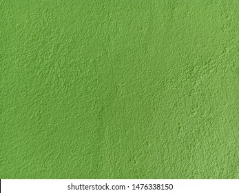 The background is made of green patterned concrete.