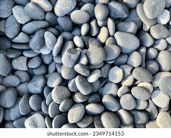 The background is made of large pebbles of gray color. The texture is made of gray pebbles. Pebbles for garden paths