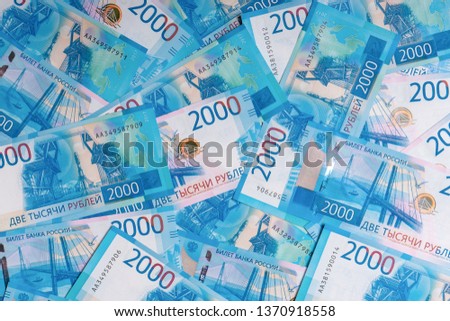 Background made of new russian money banknotes of two thousand roubles. Success in business, finance, wealth concept