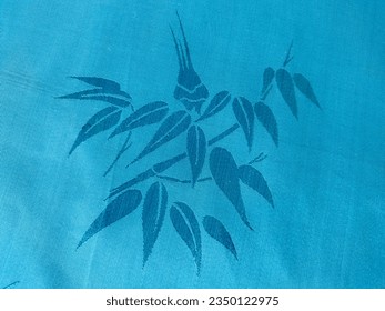 The background is made of patterned blue fabric.