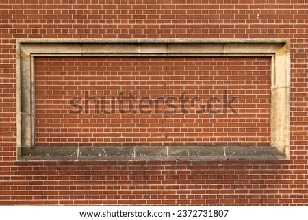 background made of red brick with a closed window in the middle