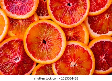 Background made of ripe juicy blood orange slices. Top view