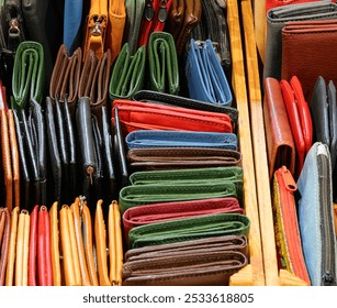 background of many colorful leather wallets and coin purses handmade by the skilled artisan for sale in the leather shop - Powered by Shutterstock