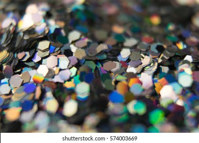 background of many small silver sequins, shimmering in different colors